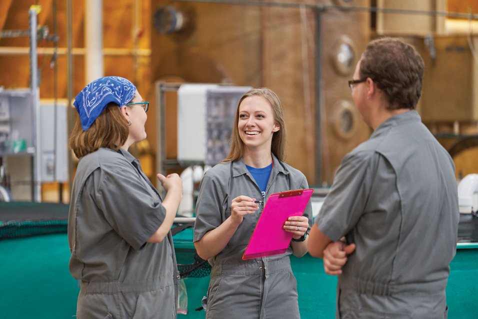 AquaBounty Employees talking at a salmon land-based farm 